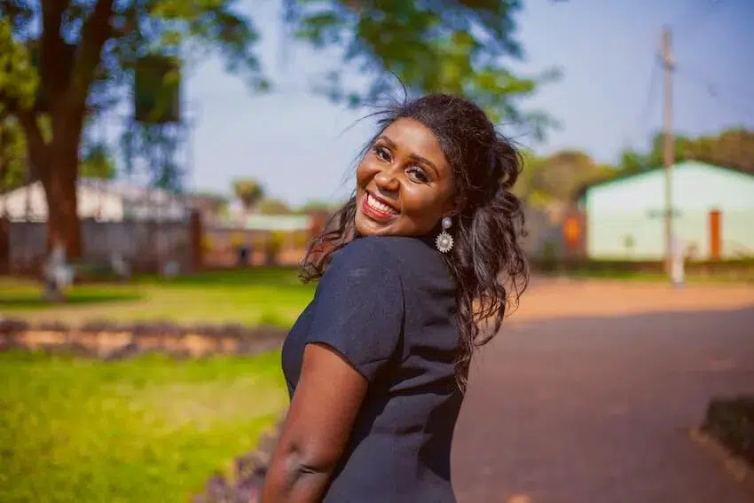 a smiling woman with her head turned to the left looking at the camera