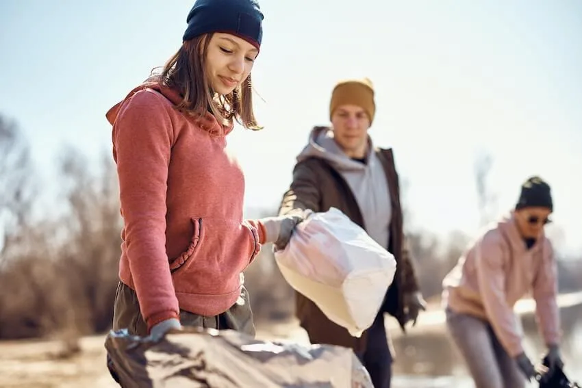 group of volunteers picking up trash