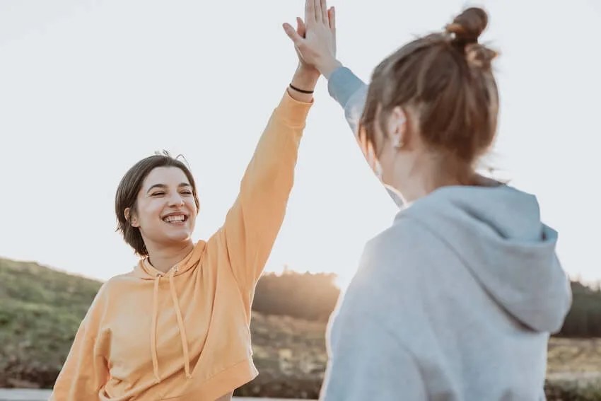 two women high fiving each other