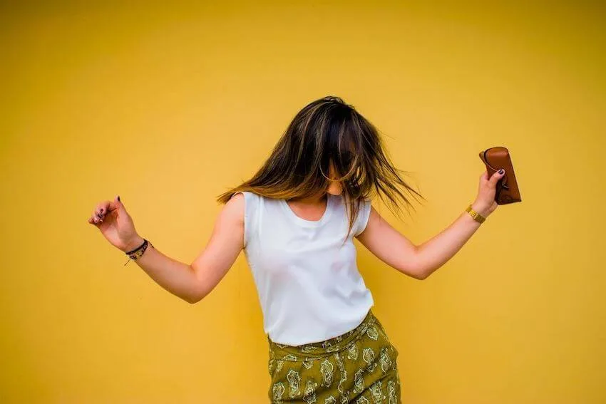 woman in a dance pose with her arms out