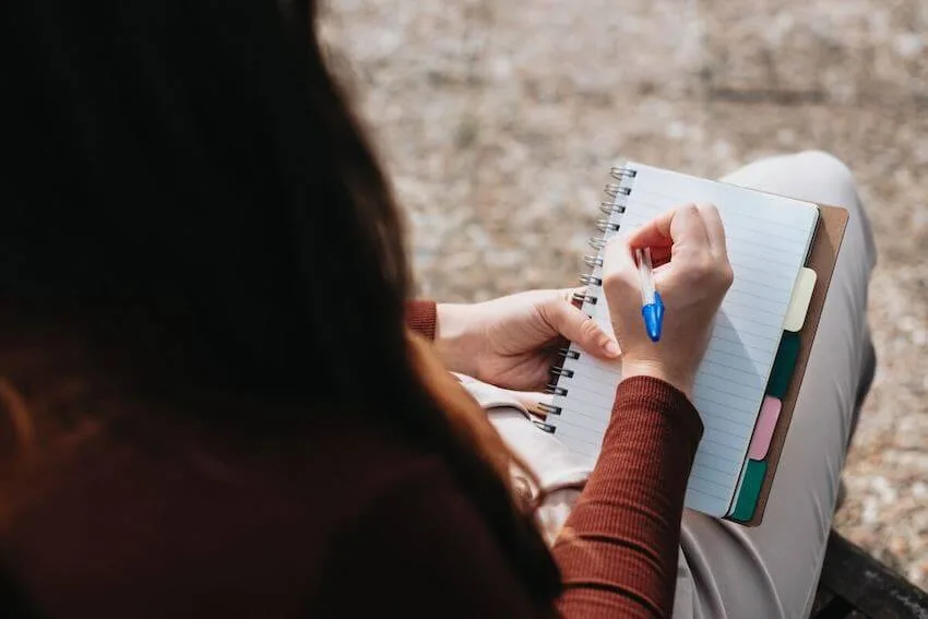 woman writing in a journal