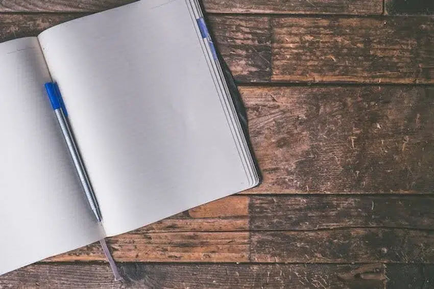 journal with a blue pen