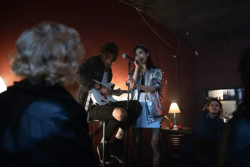 woman singing in front of a crowd