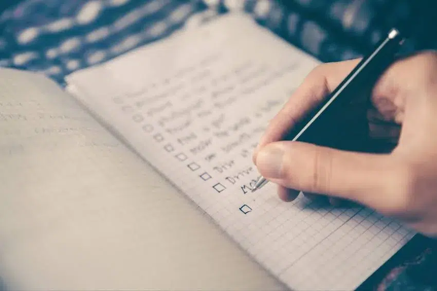 person writing a to-do list