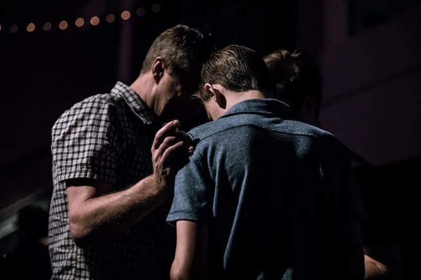man comforting another
