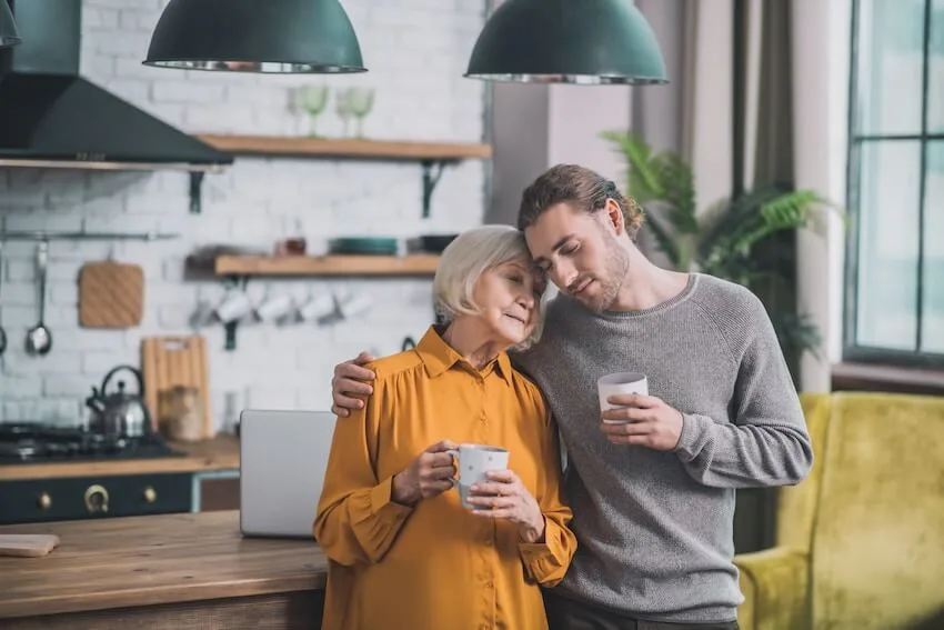 man giving an older woman a hug