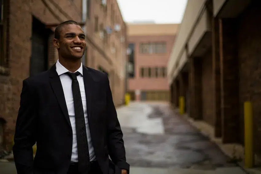 man in suit smiling and looking ahead