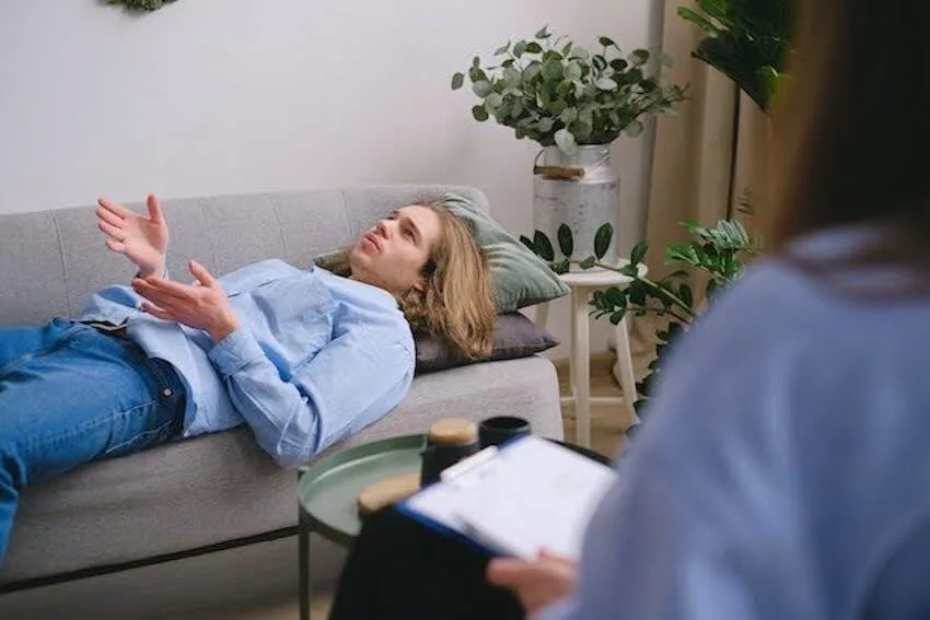 man laying on a couch talking to his therapist
