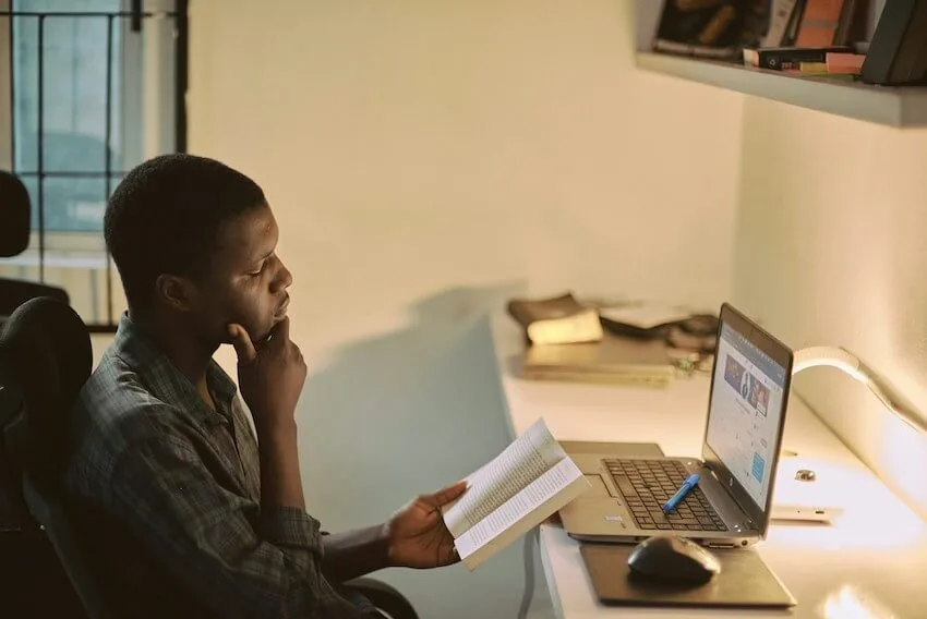 man studying in front of his laptop