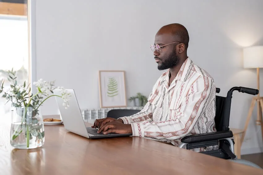 man typing on his laptop