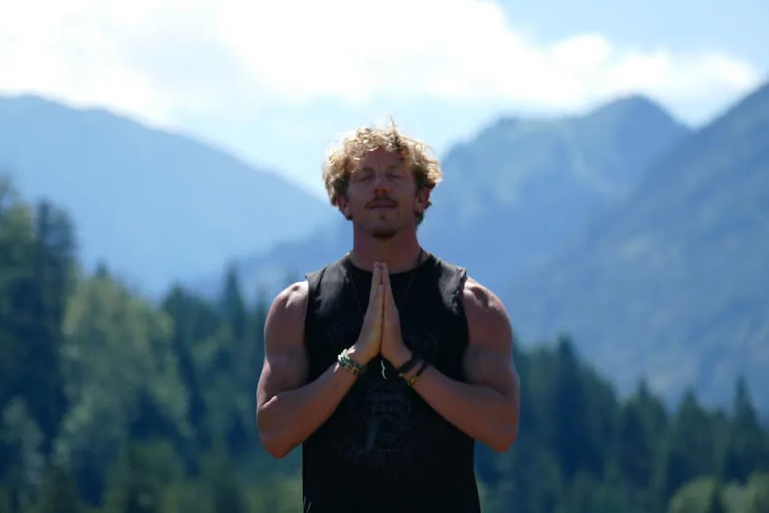 man with his hands pressed together practicing gratitude