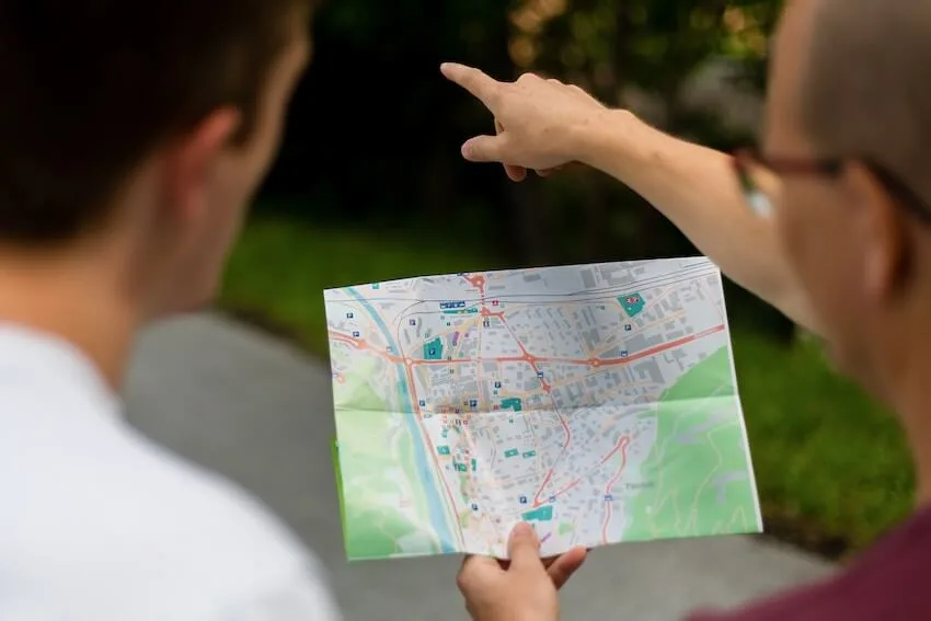two people looking at a map as one points out directions
