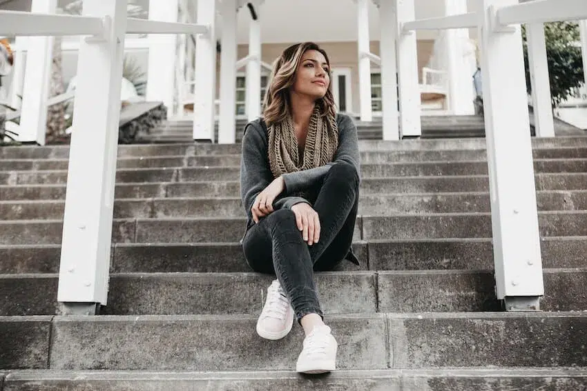 woman sitting on the steps reflecting on herself