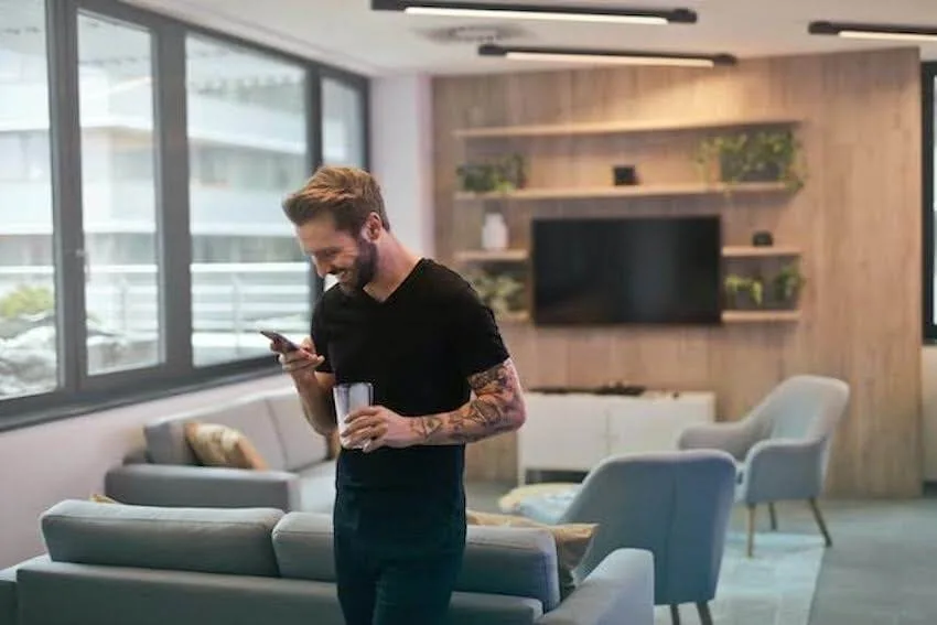 smiling man looking at his phone