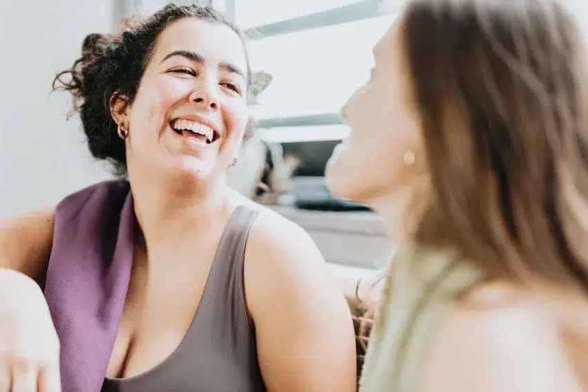 two women laughing during a good conversation