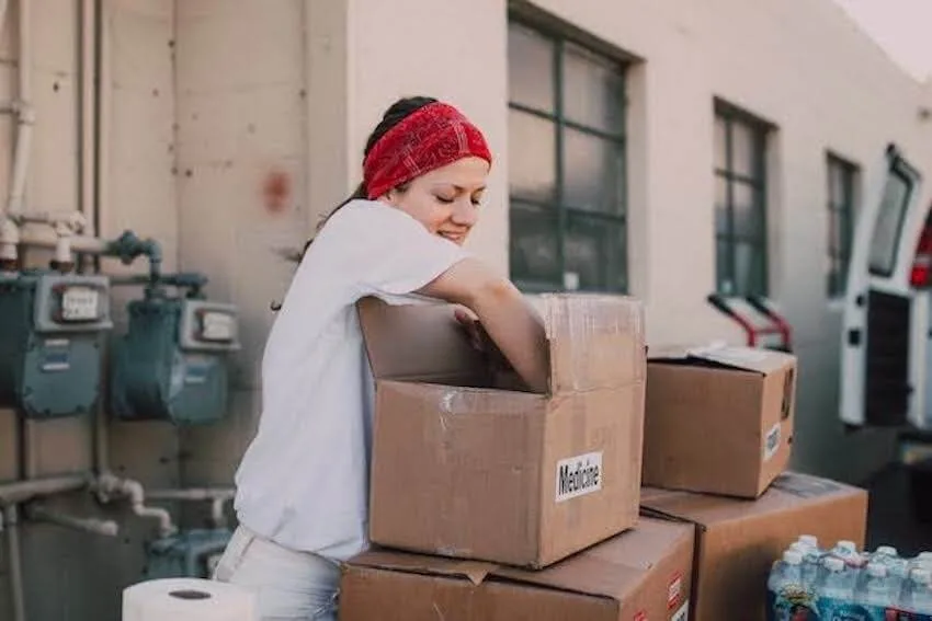 volunteer unpacking a box of medicine