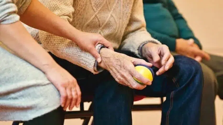 person showing compassion to an elderly man