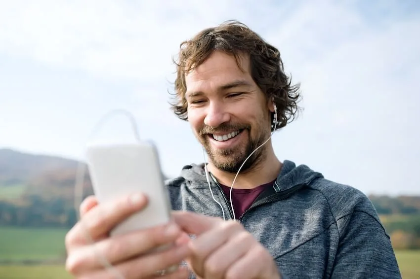 smiling man listening to music