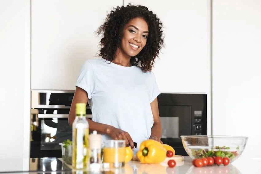 smiling woman making a salad