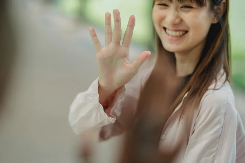 smiling woman waving