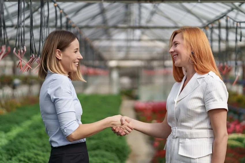 smiling women shaking hands