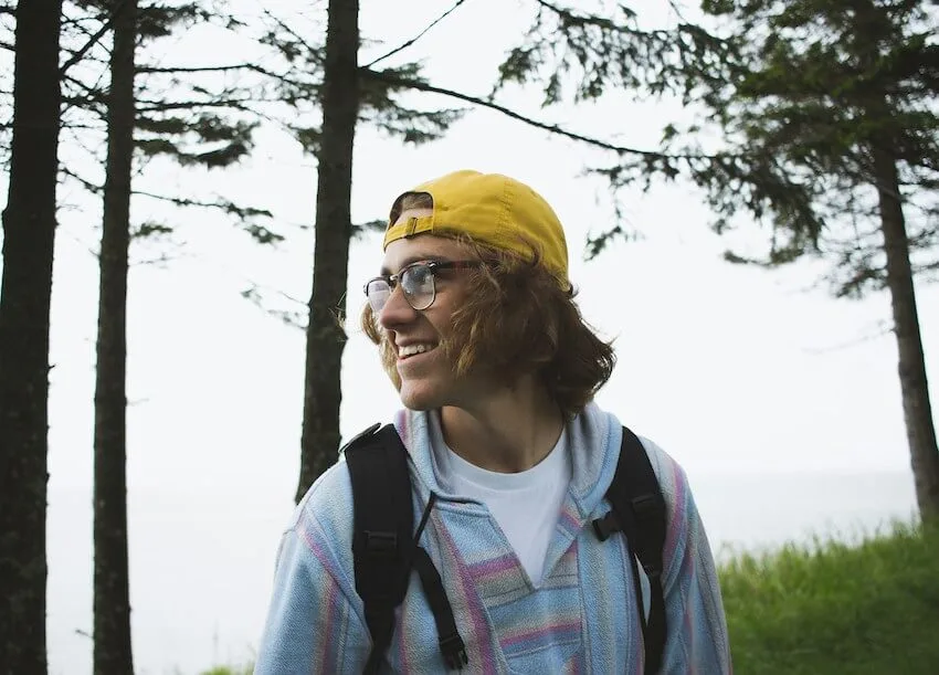 smilng man in yellow cap