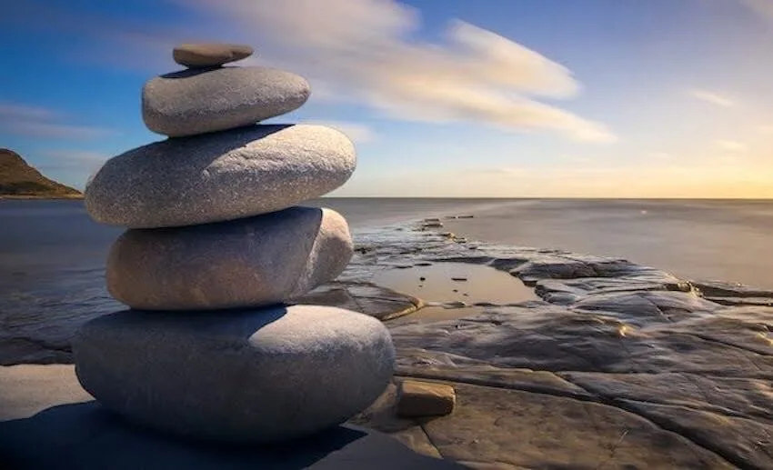 neatly stacked rocks by the ocean