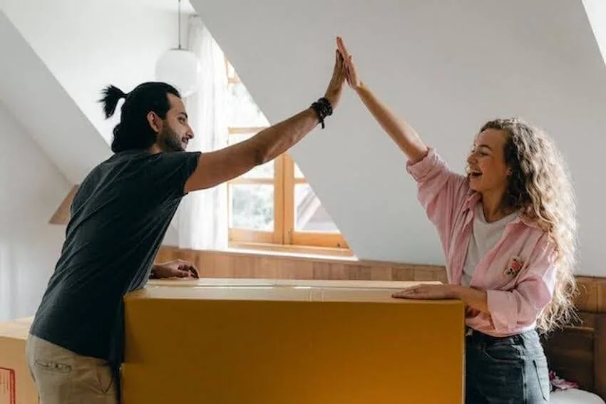 two people high fiving each other