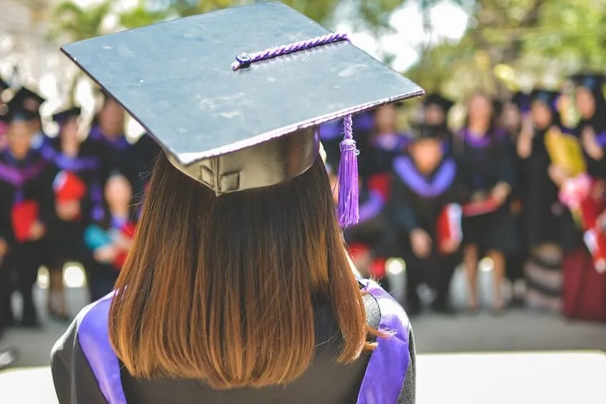 a graduate standing on stage looking at the audience