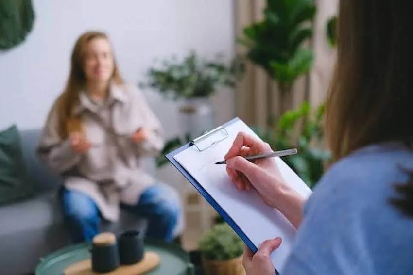 therapist taking notes as her patient speaks