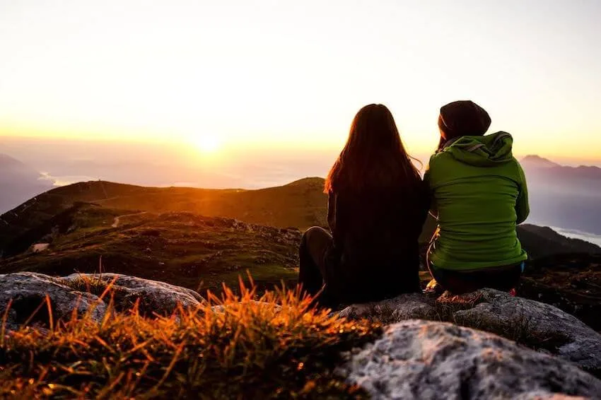two friends enjoying the sunrise