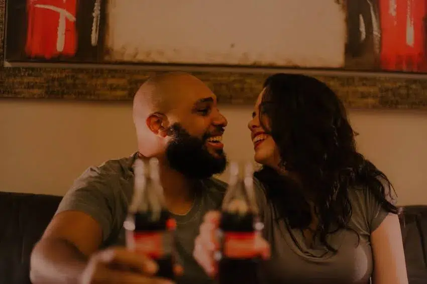 two people smiling while looking at each other