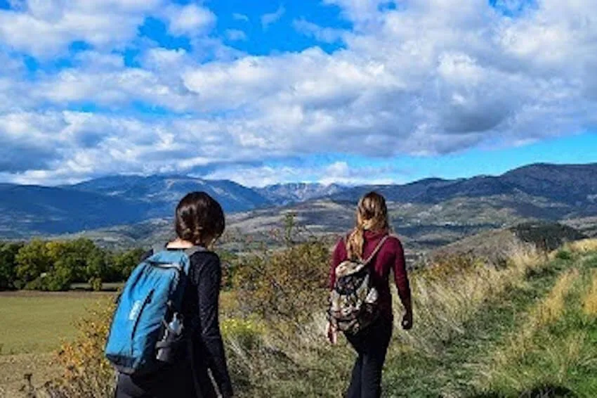 two women walking along a path outside