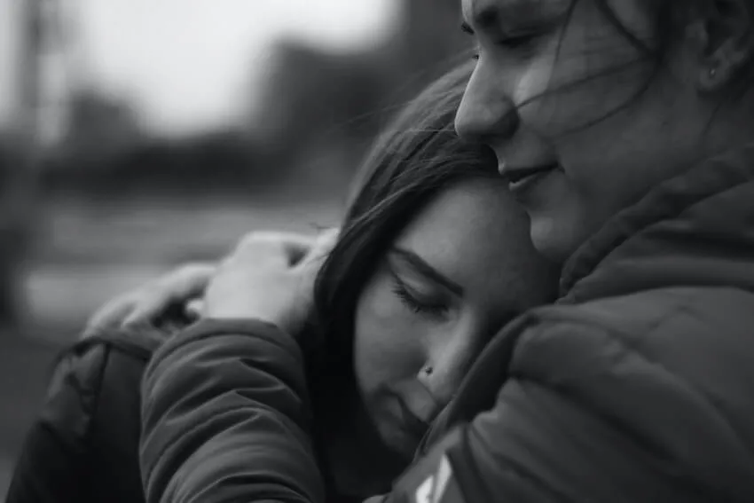 woman hugging another woman