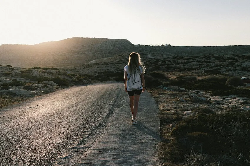 woman in shorts walking along a path