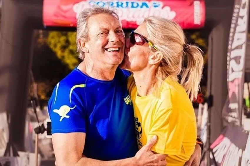 woman in yellow shirt kissing man in blue shirt