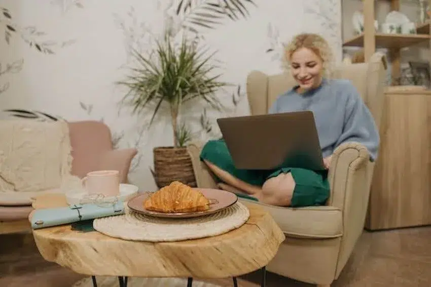 woman relaxing on a chair looking at her laptop