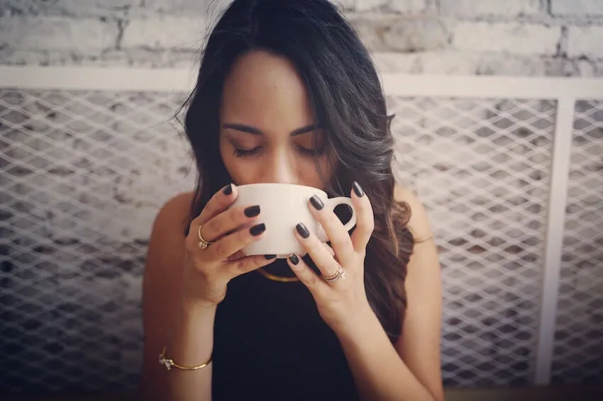 woman drinking and savoring her coffee