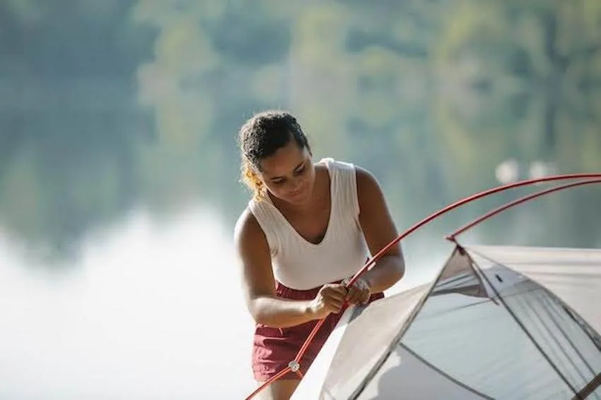 woman setting up a tent