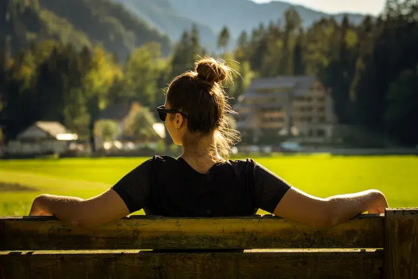 woman sitting outside on a bench