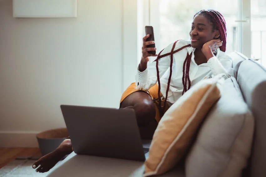 woman smiling at text message