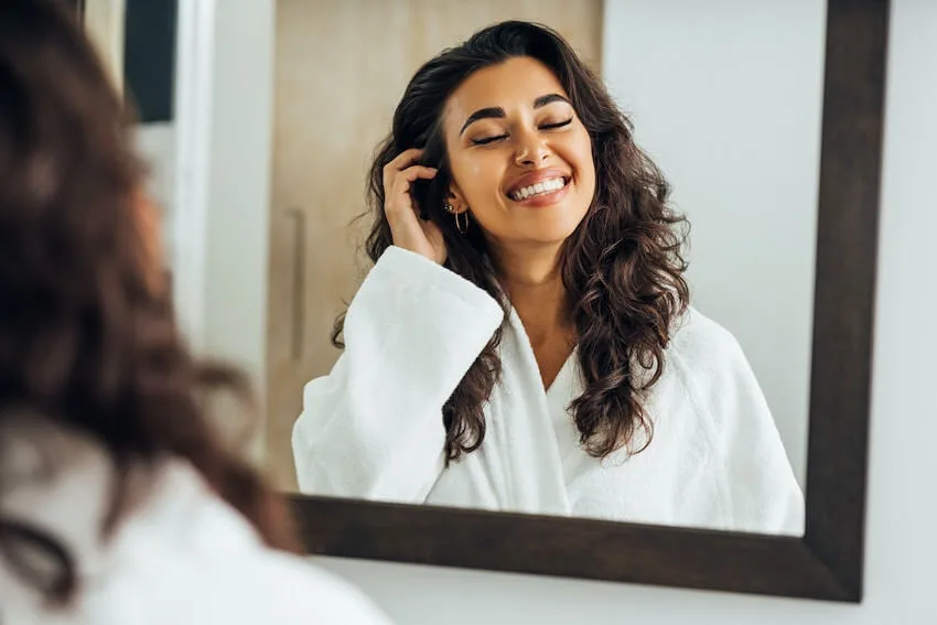 woman smiling in the mirror