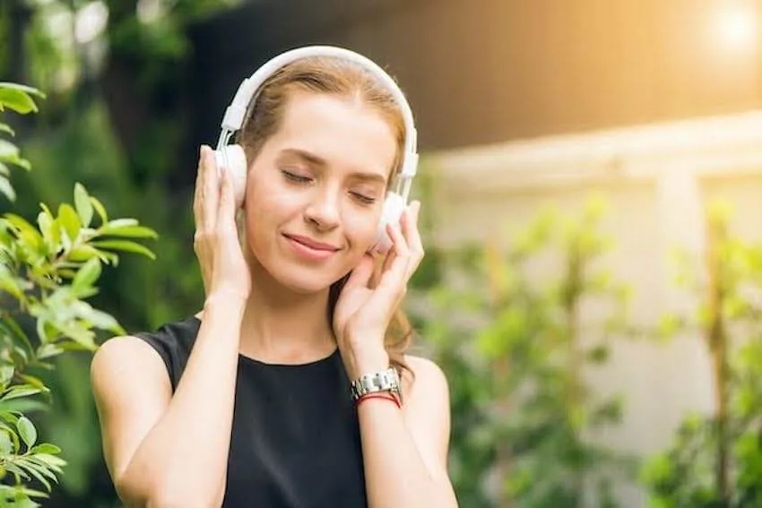 woman smiling while listening to music