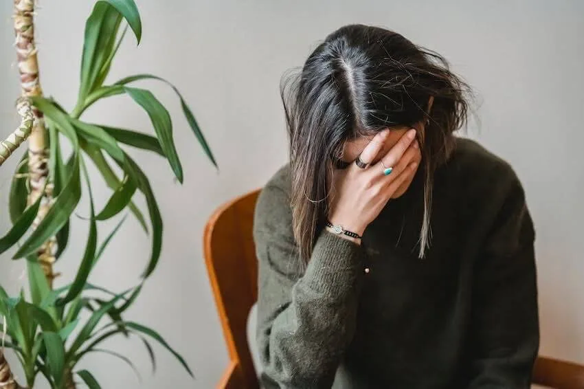 woman with her head in her right hand