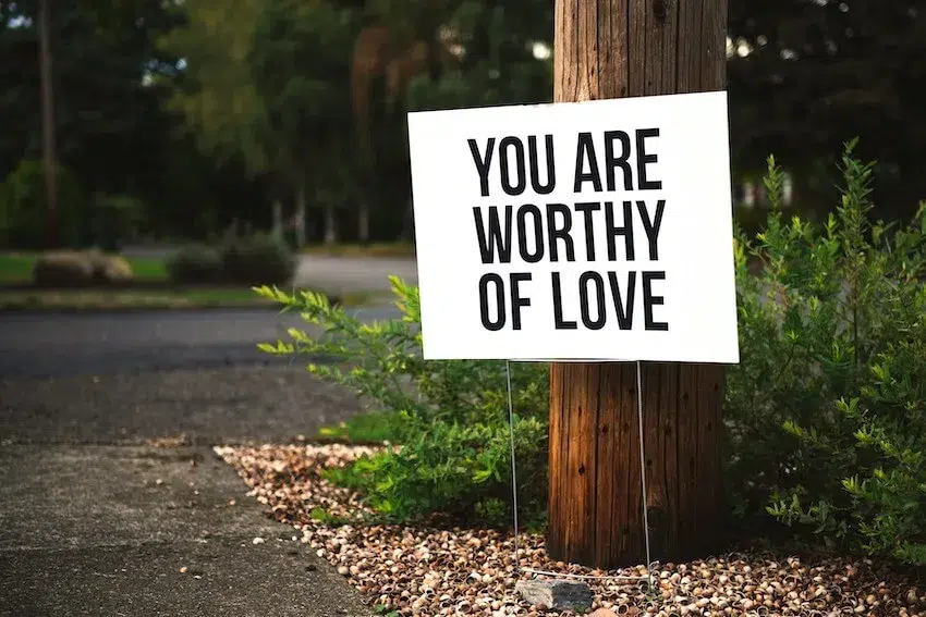 large white sign that says, "you are worthy of love"